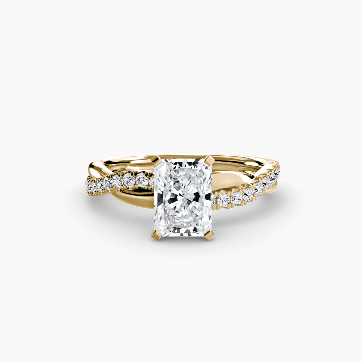 The Emerald Twist Pavé Ring in yellow gold with a radiant-cut centre stone
