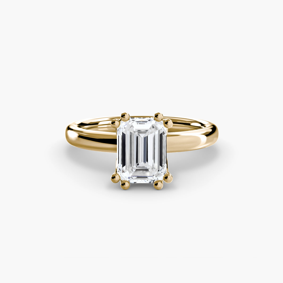 Solitaire ring in yellow gold with an emerald-cut centre stone