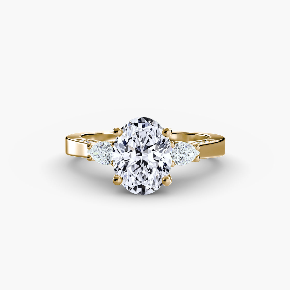 Three Stone with Pavé Shoulders engagement ring in yellow gold with an oval centre stone