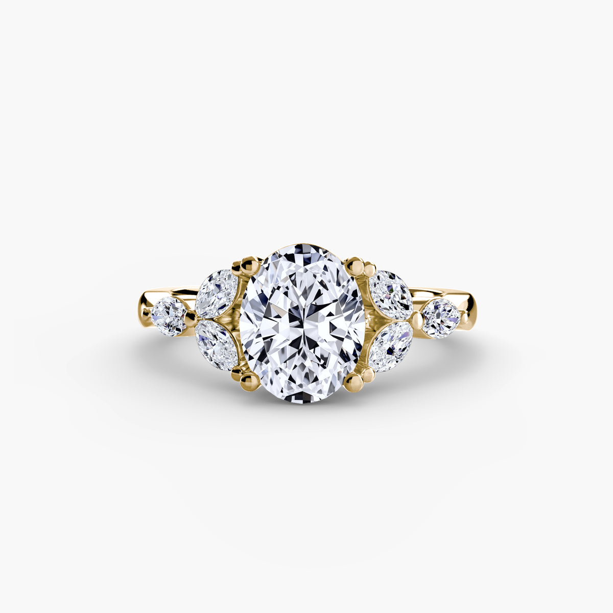 The Shoulder Cluster Ring in yellow gold with an oval centre stone