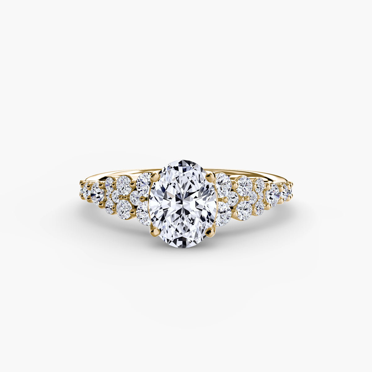 The Celestial Cluster Ring in yellow gold with an oval centre stone