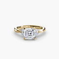 The Celestial Cluster Ring in yellow gold with an Asscher-cut centre stone