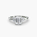 The Celestial Cluster Ring in white gold with an emerald-cut centre stone