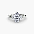 The Celestial Cluster Ring in white gold with an oval centre stone