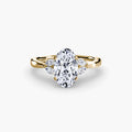 The Celestial Cluster Ring in yellow gold with an oval centre stone