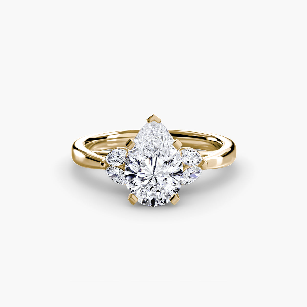 The Celestial Cluster Ring in yellow gold with a pear-shaped centre stone
