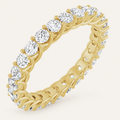 Natural diamond full eternity ring with interwoven claw design in yellow gold on an ivory background