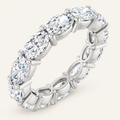 4ct oval diamond full eternity ring in white metal on an ivory background