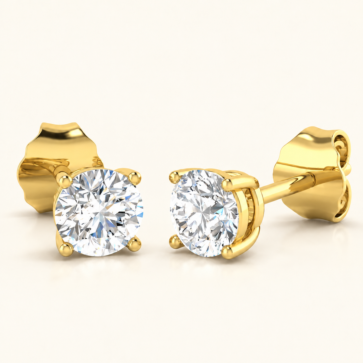 Yellow gold four-claw basket lab-grown diamond stud earrings on warm ivory