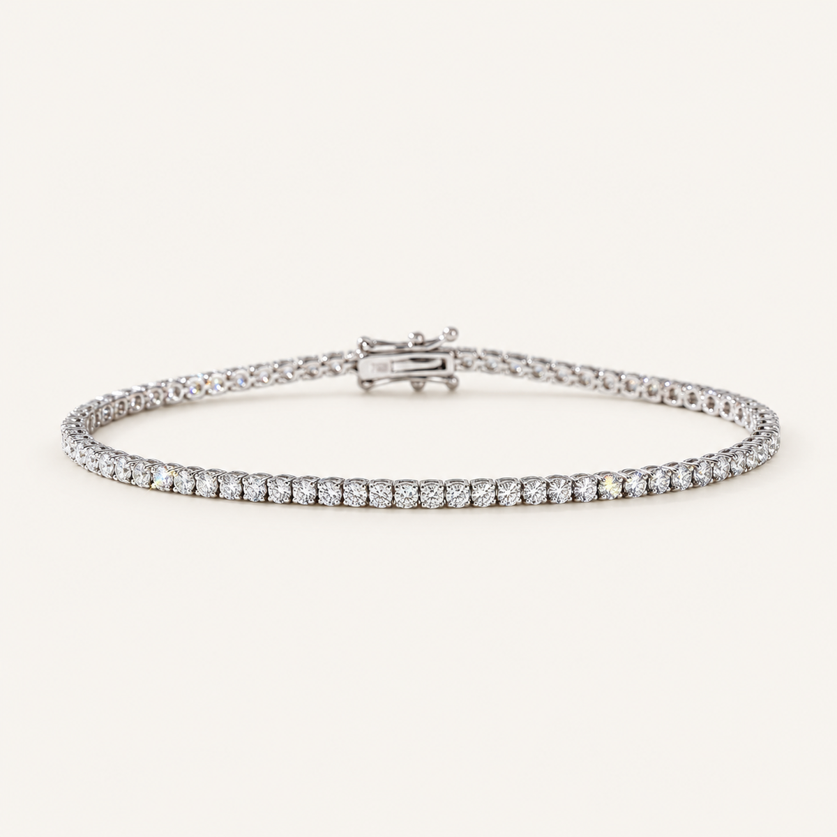 Diamond tennis bracelet in white gold on an ivory background