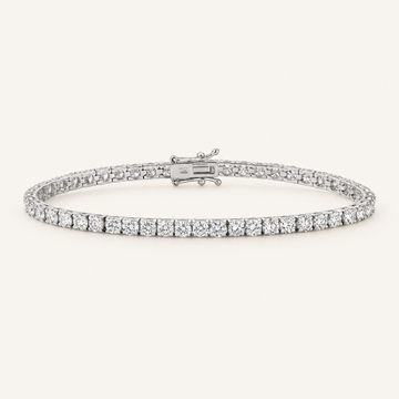 Diamond tennis bracelet in white gold on an ivory background