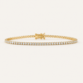 Diamond tennis bracelet in yellow gold on an ivory background