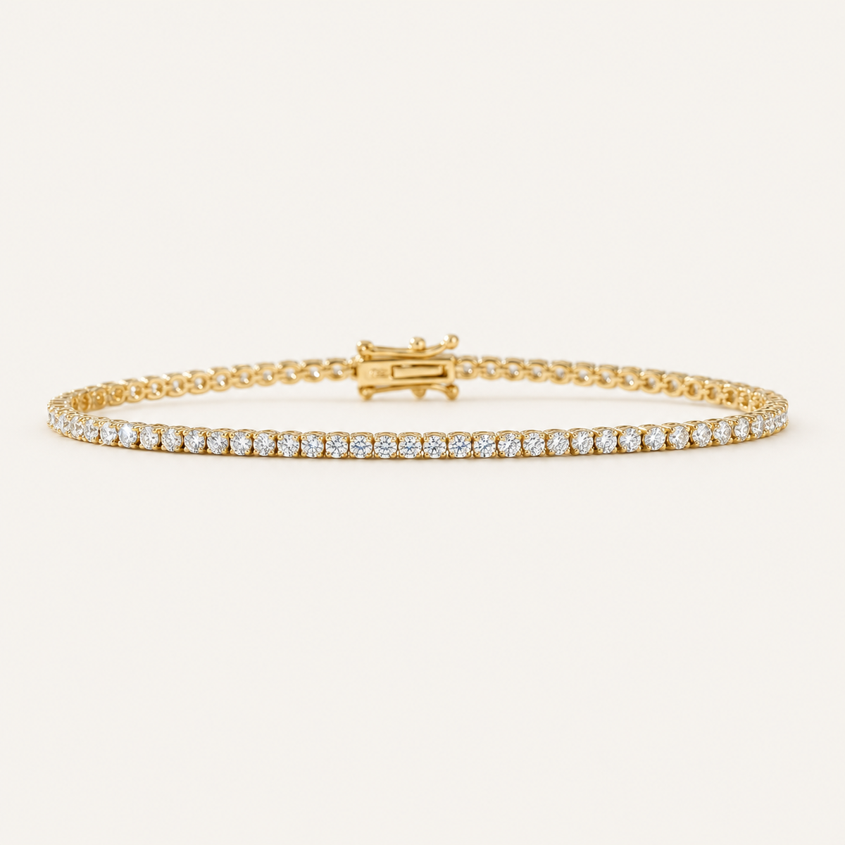 Diamond tennis bracelet in yellow gold on an ivory background