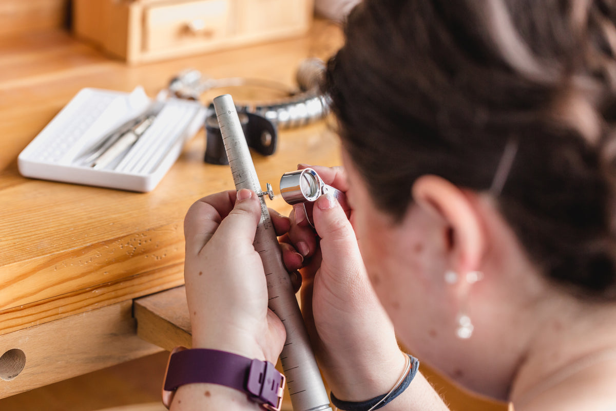 Jeweller examining a ring during the jewellery making process
